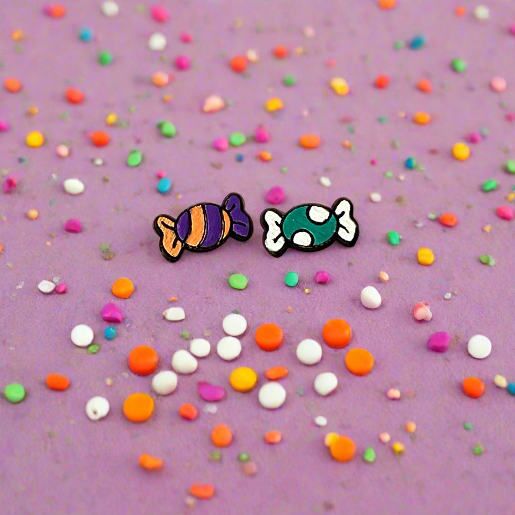 Featuring a mismatched design with a striped orange & purple candy and a teal polka dot treat